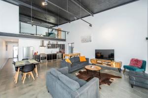 a living room with two couches and a table at Vasse NewYorker Townhouse in Vasse