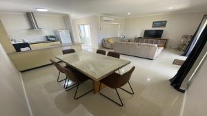 a dining room and living room with a table and chairs at Unit 48 Seafront Estate in Jurien Bay