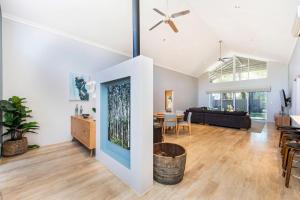 a living room with a ceiling fan and a dining room at Bussell Hideaway Haven in Broadwater