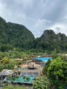 a resort with two swimming pools and a mountain at Up to 6 pax @ Sunway Onsen, Lost World Tambun in Kampong Batu Lapan