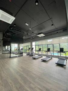 a gym with treadmills and ellipticals in a room at Up to 6 pax @ Sunway Onsen, Lost World Tambun in Kampong Batu Lapan