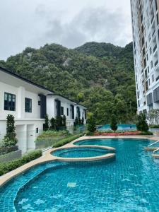 a row of swimming pools in front of a building at Up to 6 pax @ Sunway Onsen, Lost World Tambun in Kampong Batu Lapan