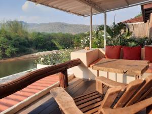 a deck with a table and chairs and a view at Pingplalee Resort in Sai Yok