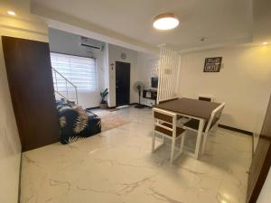 a living room with a table and a chair at Atria's Bed & Breakfast at Laiya in Laiya