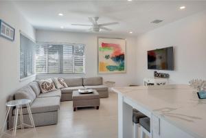a living room with a couch and a table at Art Deco Pool house mile and a half to beach Pets Welcome in Lake Worth