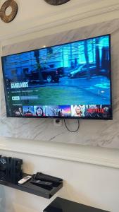 a flat screen tv hanging on a wall at The Glory Villas in Batu