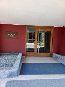 an entrance to a building with a glass door at Departamento Edificio Aqua Pucón in Pucón