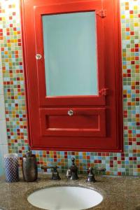 a bathroom with a red mirror and a sink at Beautiful, Historic Family Home near Lake Merritt in Oakland