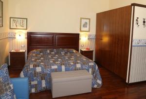 a bedroom with a large bed with a blue quilt at B&B La Vetreria Almarù in Catania