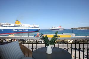 a vase on a table with ships in the water at Esperance 1 in Ermoupoli