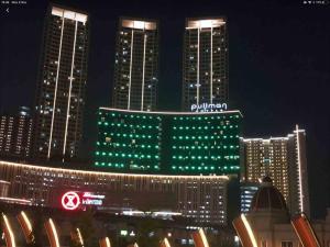 a lit up city at night with green lights at Madison Park Apartment 2 Bedroom near Central Park Mall in Jakarta