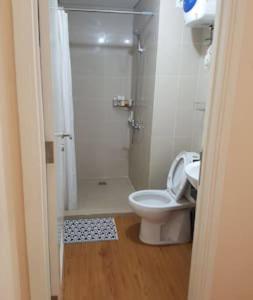 a bathroom with a toilet and a shower and a sink at Madison Park Apartment 2 Bedroom near Central Park Mall in Jakarta