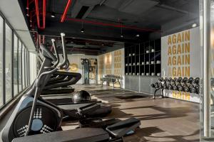 a gym with a lot of exercise equipment in a room at December Hotel in Nha Trang