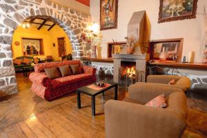 
a living room filled with furniture and a fire place at Hotel Samanapaq in Ollantaytambo
