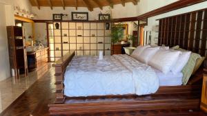 a bedroom with a large bed with white pillows at Villa Olympia, St James Club - Luxury Open plan Villa, with Private Pool & 2 Kitchens in Bats Cave