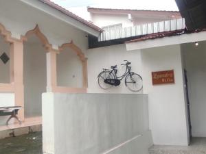a bike hanging on the side of a building at Aliandra Villa by The Lavana in Yogyakarta