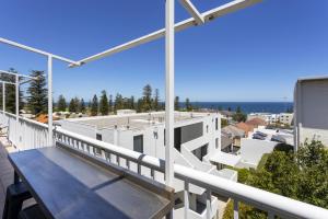 a balcony of a house with a view of the ocean at Cottesloe Azura Apartment in Perth