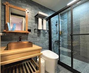 a bathroom with a sink and a shower at 95 Pavilion in Jiufen