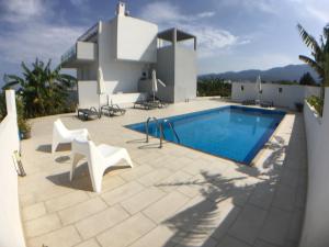 a villa with a swimming pool and a house at Xenos Villa 3 - Luxury Villa With Private Pool Near The Sea. in Tigaki