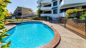 a swimming pool in front of a building at Views, Pool, Air Conditioning - Karoonda Sands Welsby Pde, Bongaree in Bongaree