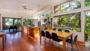 an open kitchen and dining room with a table and chairs at Decked out for a Fantastic Holiday - Winnett St, Woorim (Upstairs only) in Woorim