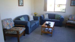 a living room with two couches and a coffee table at Light, Airy 1st Floor Unit - Marbrin Close, Bellara in Bellara