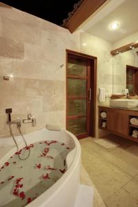 a bathroom with a bath tub with blood on the floor at Villa Alu Lima in Seminyak