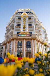 a building with a sign on the front of it at GOLDEN HOTEL 2 