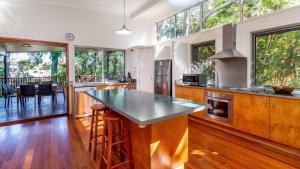 a kitchen with a large island with a counter top at Decked out for a Fantastic Holiday - (Whole house) Winnett St, Woorim in Woorim