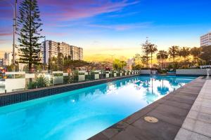 a swimming pool on the roof of a building at Avalon Apartments - Wow Stay in Gold Coast