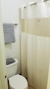 a bathroom with a white toilet and a shower at Hotel 2 Queen Beds Hotel Room 125 Booking in Stillwater