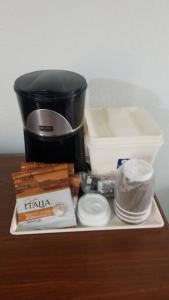 a counter top with a coffee maker and other items at Hotel 2 Queen Beds Hotel Room 125 Booking in Stillwater