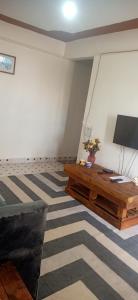 a living room with a couch and a television at Zuri Stays Machakos Town in Machakos