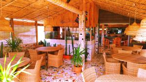 a restaurant with wicker tables and chairs and tables and chairs at Hotel La Hasienda in Kupang