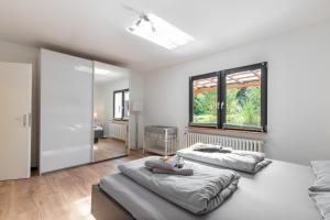 a bedroom with two beds and a large window at Großer Plöner See, Terrasse, Garten, Grill, Garage in Plön