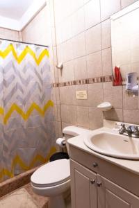 a bathroom with a toilet and a sink and a shower at Finca Pura Villa in San Lorenzo