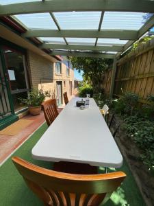 una mesa blanca y sillas en un patio en ADA Homestay en Doncaster