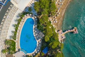 an aerial view of a resort with a swimming pool and a beach at Utopia Beach Club in Okurcalar