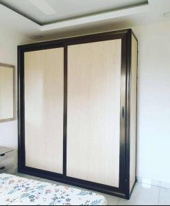a sliding glass door in a room with a bed at Appartement luxueux ouaga2000(2 chambres ) in Ouagadougou