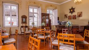 a dining room with wooden tables and chairs at Casa Colonial Quito in Quito