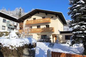 a large house with a balcony in the snow at Chalet Jasmin in Zell am See