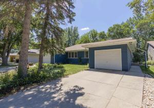 a house with a garage in front of a driveway at Blue House in Sioux Falls