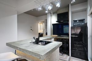 a kitchen with a granite counter top and a sink at Osaka Bay Wheel in Osaka