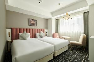Tempat tidur dalam kamar di Cross Hotel Sapporo