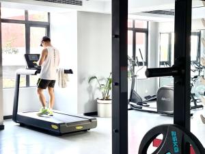 a man walking on a treadmill in a gym at Prince Mall Appartment - 400m to Sokha Beach in Sihanoukville