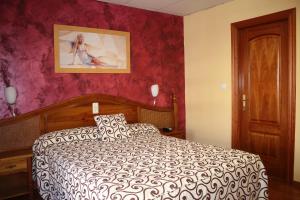Postel nebo postele na pokoji v ubytování Hotel La Curva