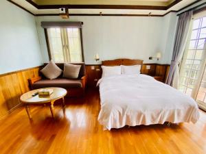 Postel nebo postele na pokoji v ubytování 見晴花園山莊Sunshine Villa