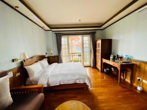 Postel nebo postele na pokoji v ubytování 見晴花園山莊Sunshine Villa