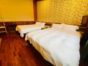 Postel nebo postele na pokoji v ubytování 見晴花園山莊Sunshine Villa