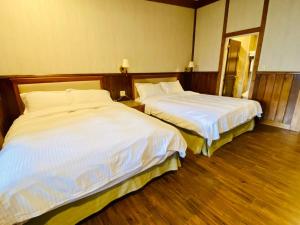 Postel nebo postele na pokoji v ubytování 見晴花園山莊Sunshine Villa
